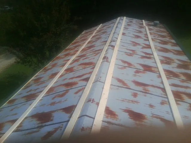 Rusted metal roof panels with new wood purlins before replacement — Storm Damage Roof Repair in Pickens by Roofing Brothers