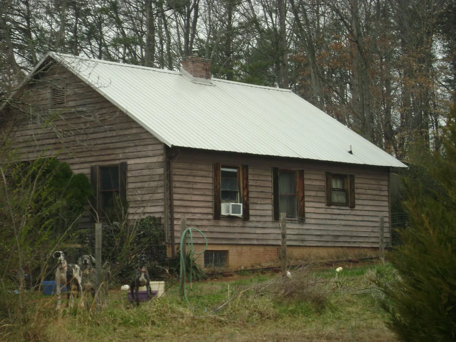 White metal roof on an old wood sided farmhouse, from a Metal Roof Installation job in Pickens